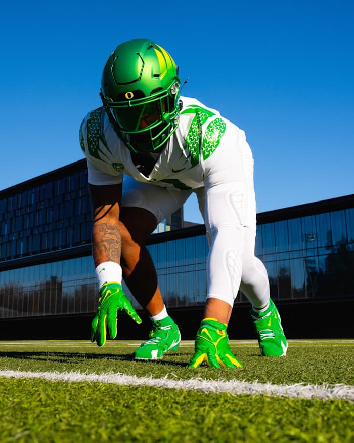 Oregon Ducks defensive lineman Brandon Dorlus models a uniform for the Pac-12 Championship against Washington.